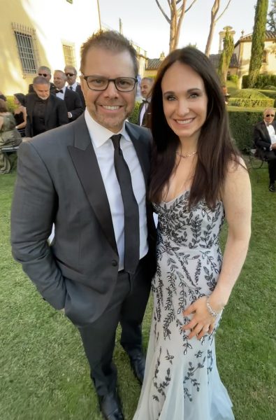 Hull and his wife, Kelly, at an outdoor party in Hollywood with others in the background
