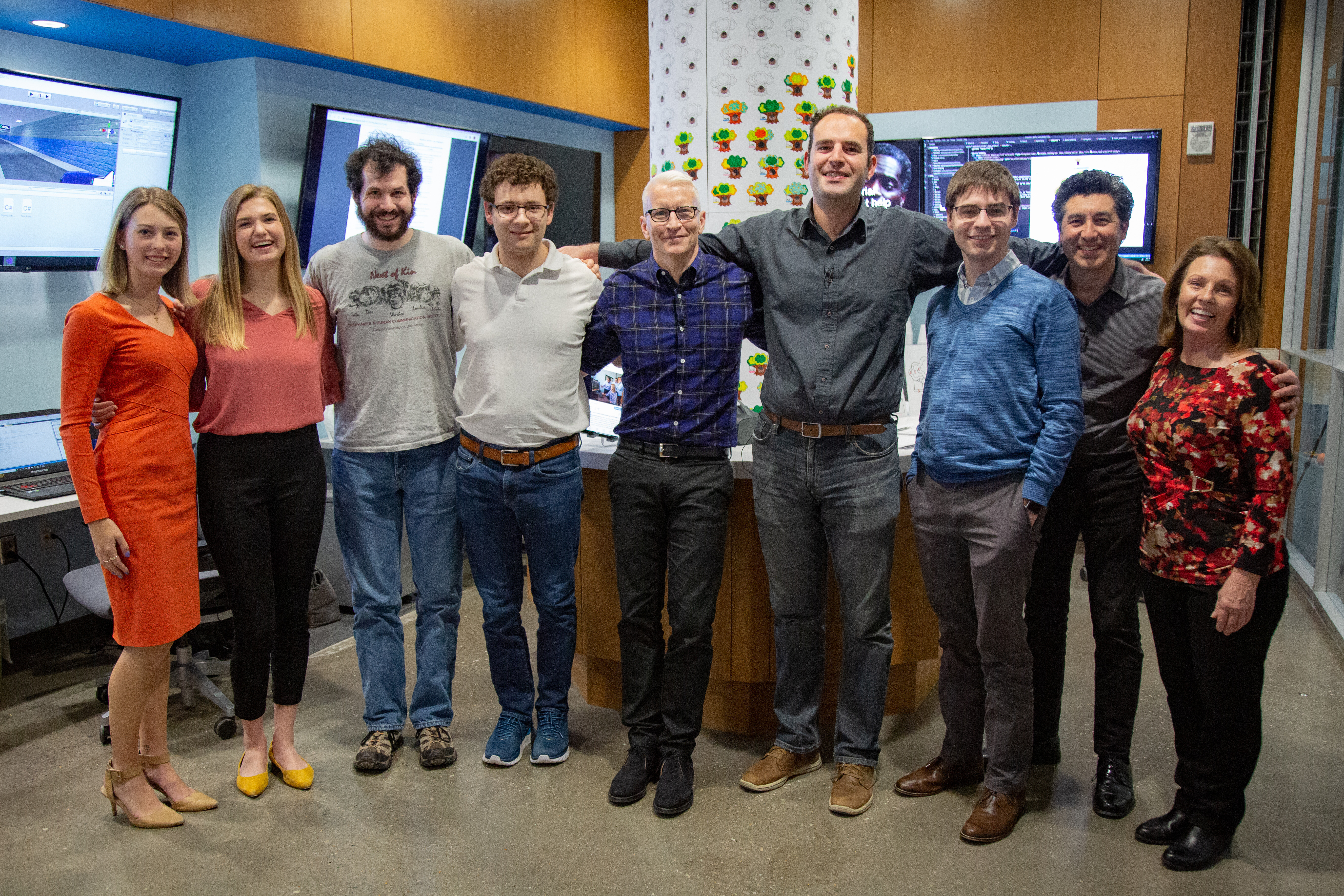 FCAI staff take photos with Anderson Cooper during the filming of a 60 minutes episode.