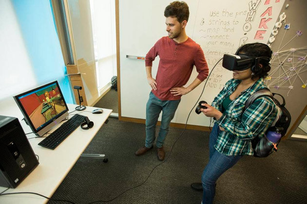 A virtual reality environment where sophomore Chirayil, a makerspace ambassador, watches a Van Gogh painting come to life in 3D. Standing to the left is senior Miguel Moravec, an augmented reality and virtual reality ambassador at the Wond'ry. (Steve Green/Vanderbilt)