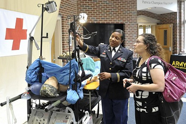 Maj. Jovitta Chandler, BSN, R.N., left, talks with Danica Ninkovic, MSN, R.N., about the U.S. Army Forward Surgical Team, which set up a simulated battleground operating room at the School of Nursing’s Frist Hall earlier this week. (photo by Joe Howell)