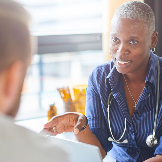 Doctor speaking to patient on reducing afib stroke risks.