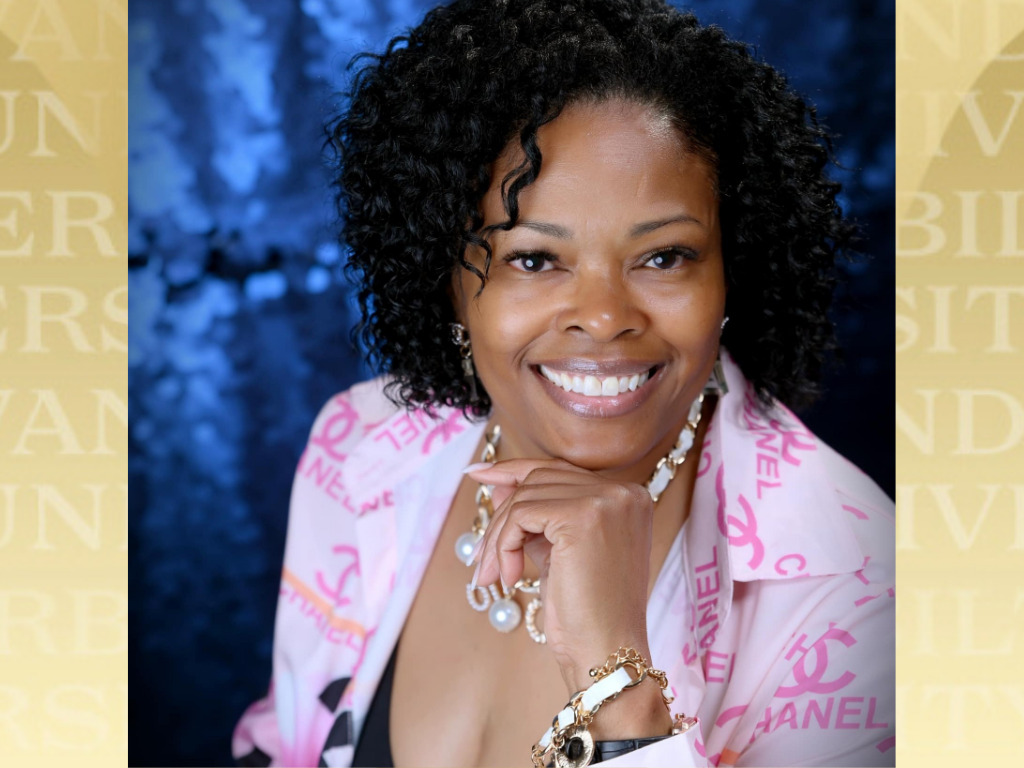 Sheila Elder headshot with Vanderbilt gold background.