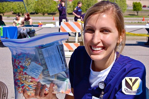 VUSN student Stephenie Plowden holds a bag of medications collected at the Dickson County drug disposal event. (photo by Carrie Plummer)