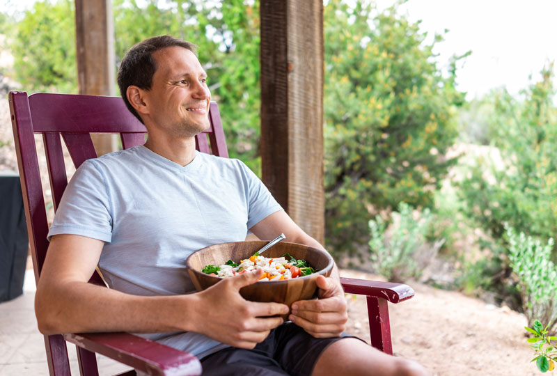 Man enjoying a healthy lunch break and sitting outside.