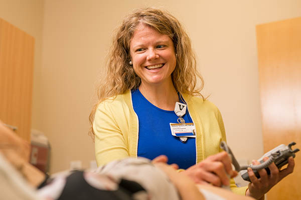 Kameron Brainard, MSN'12, CNM, and patient