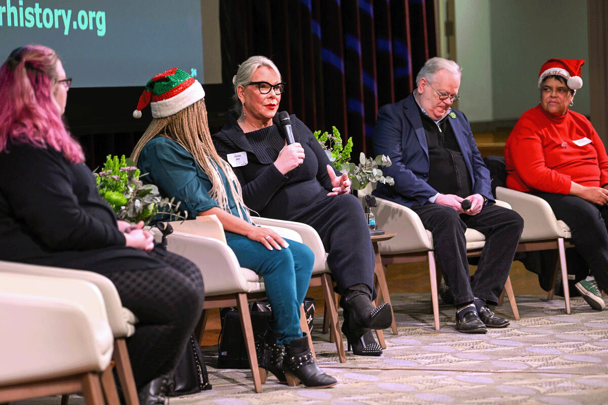 members of Nashville's LGBTQI+ community engage in a panel discussion on stage at the Nashville Public Library
