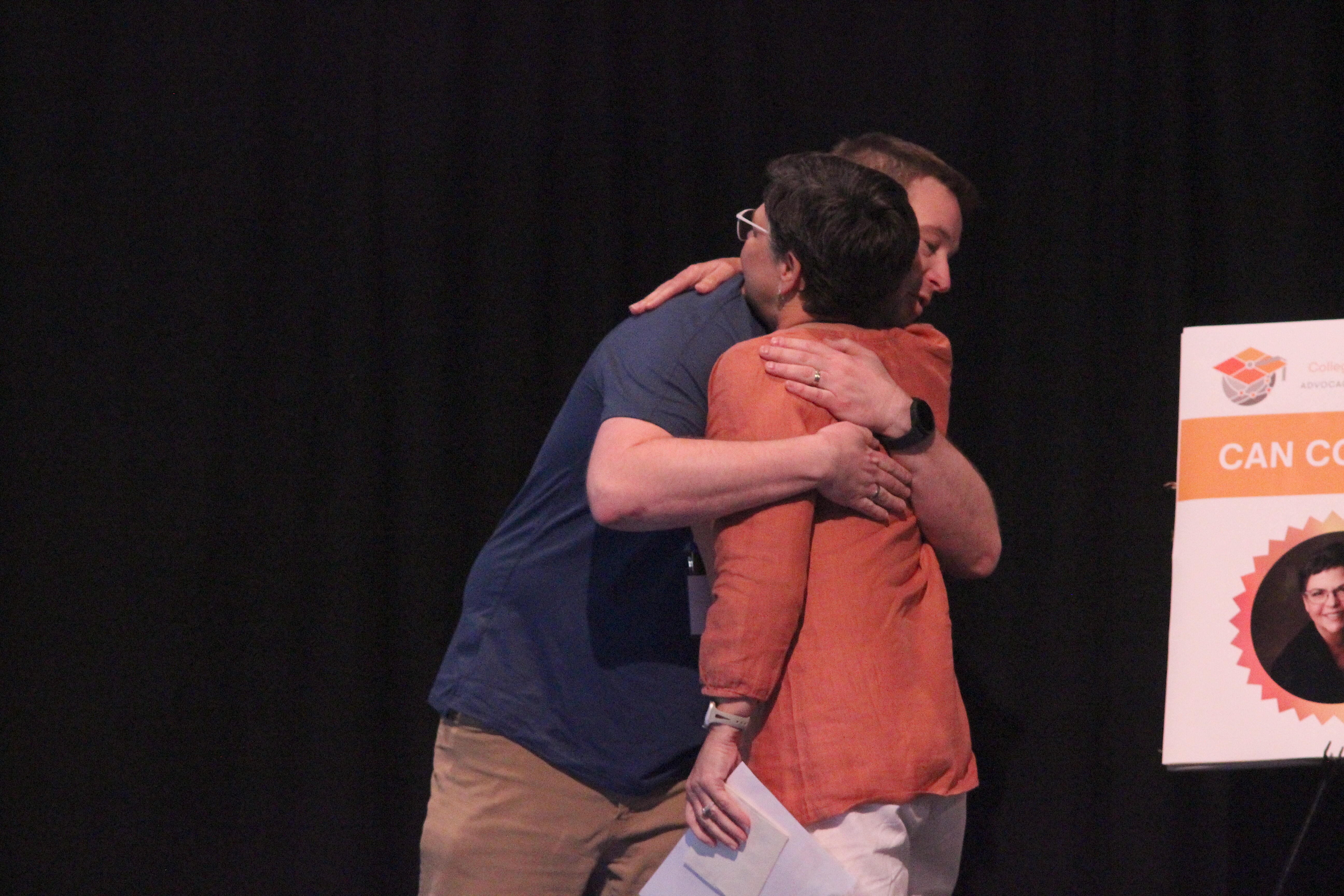 Then director of the College Autism Network Brad Cox embraces winner of one of the 2023 College Autism Network awards at the College Autism Summit 2023.