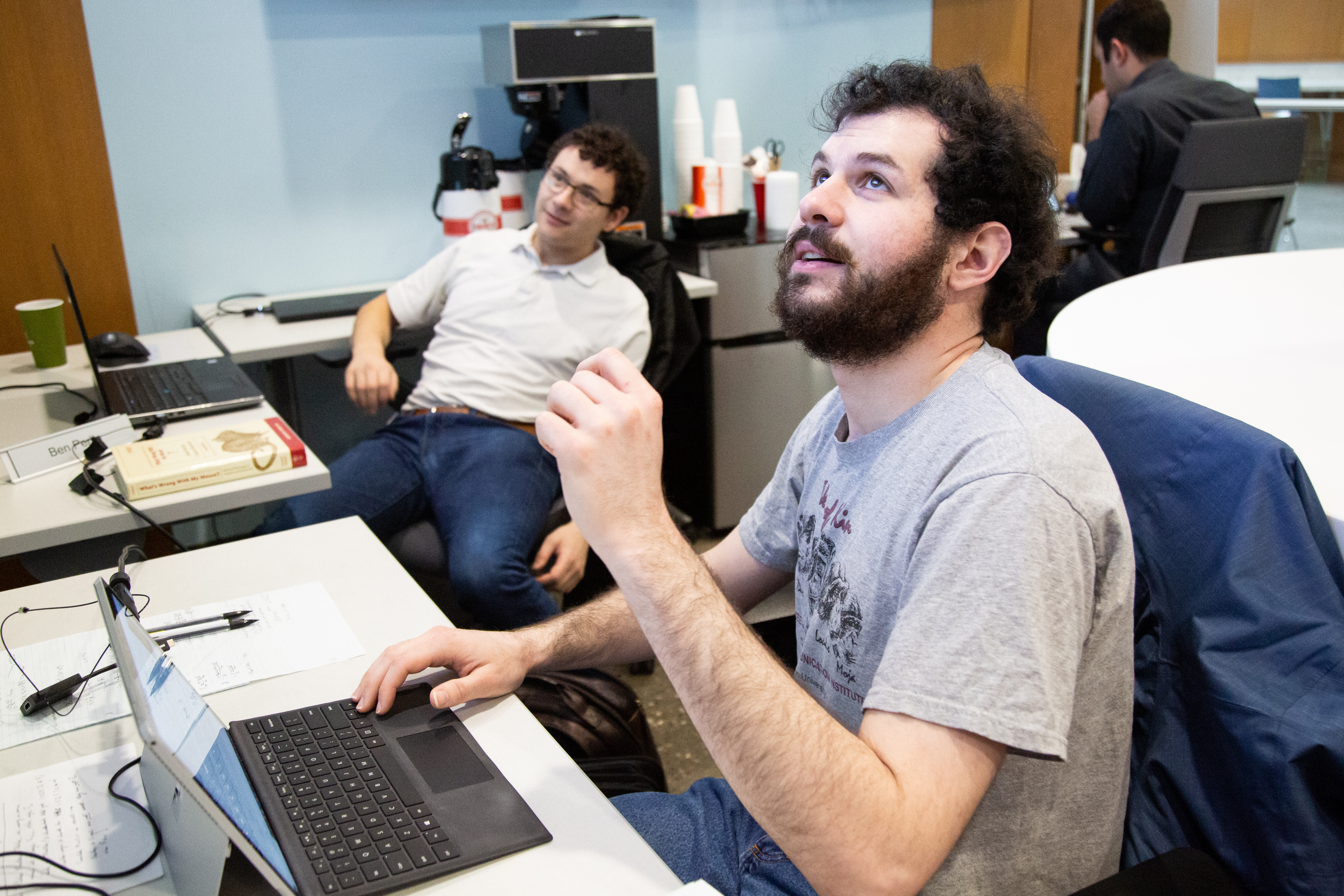 Former FCAI students Noah and Ben discuss some work appearing on one of the large collaborative screens in the center. Former FCAI students Noah and Ben discuss some work appearing on one of the large collaborative screens in the center.