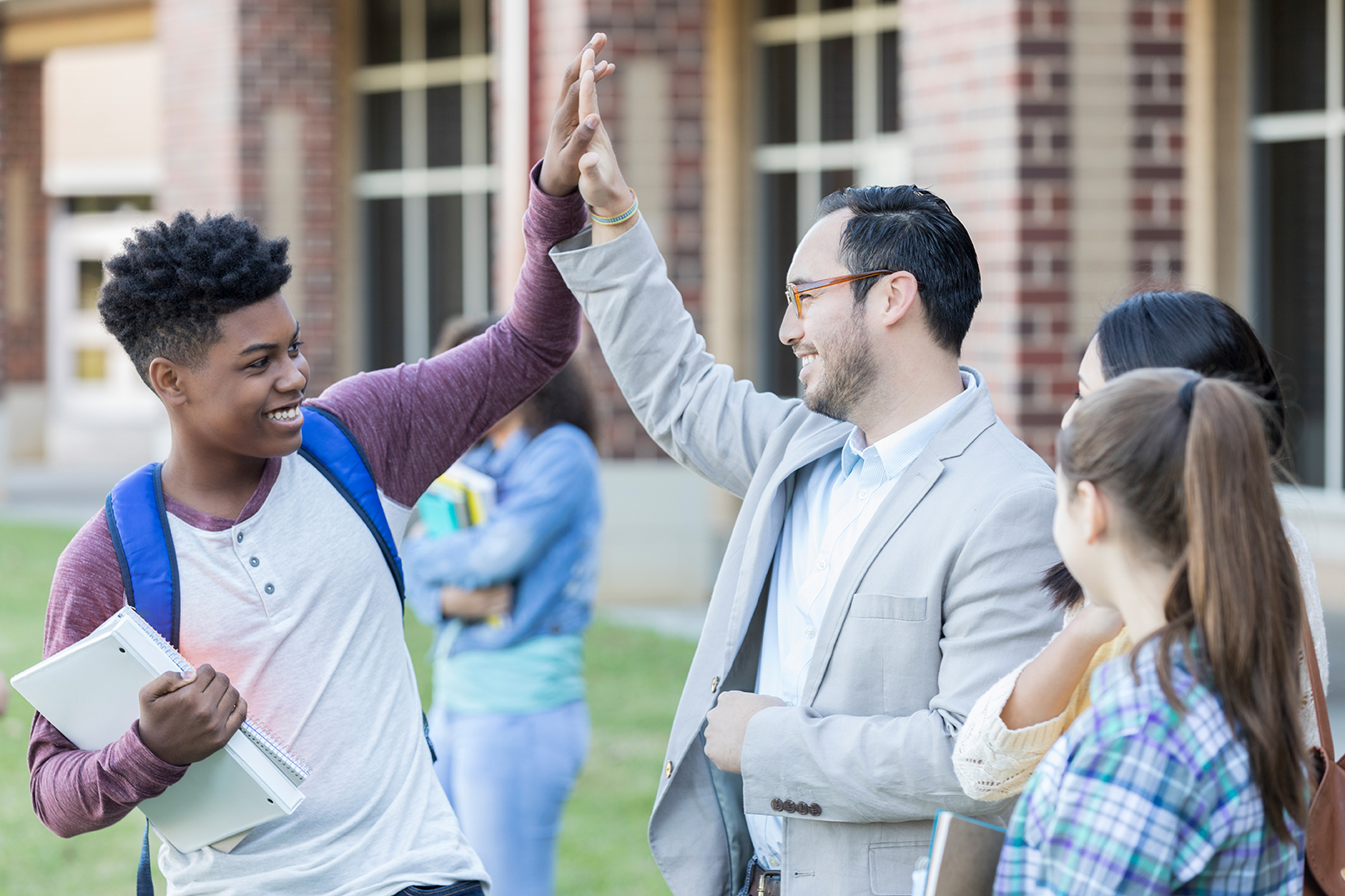 student high-fiving teacher
