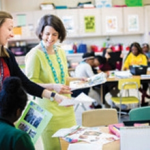 student teachers looking at student projects