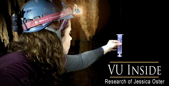 Oster wearing headlamp in cave