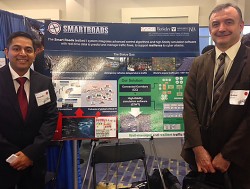 SmartRoadsbooth Gabor Karsai standing at expo booth with unidentified man.