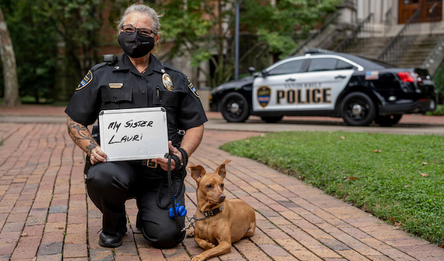 Vanderbilt Police Sergeant Cheryl Bradley with K9 Levi shows who she masks up for as she practices healthy behaviors outside Kirkland Hall.