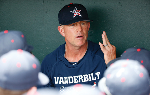 Corbin briefs his players in the dugout at Ameritrade Park in Omaha during last summer’s College World Series. (JOHN RUSSELL)