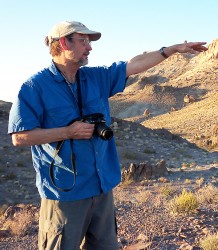 Calvin Miller standing on a hilly landscape
