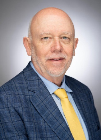 photograph of John Geer in blue suit