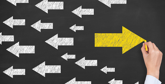 field of white arrows with one larger yellow arrow pointing in opposite direction