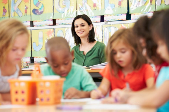 Group Of Elementary Age Children In Art Class With Teacher