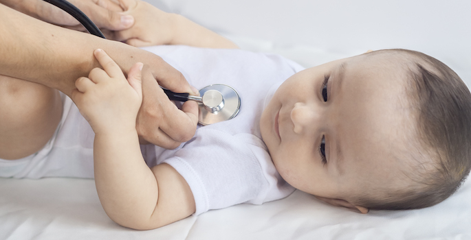 The pediatrician examining baby with a stethoscope.