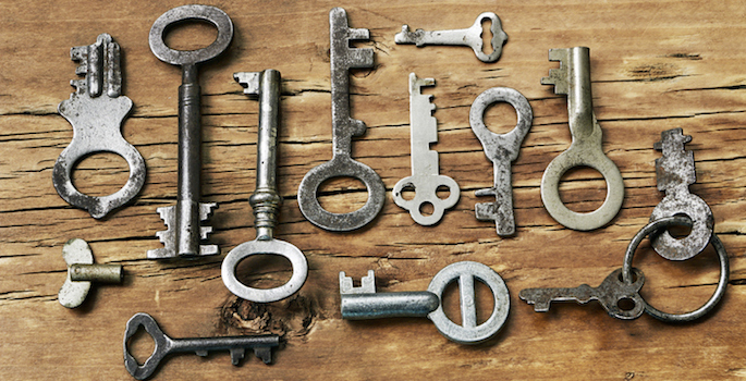 Old fashioned keys on wooden background