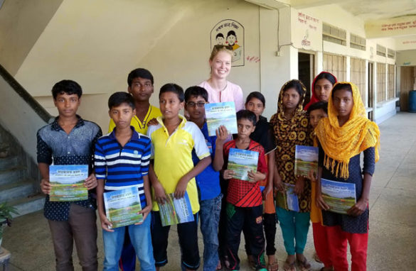 Chelsea Peters poses with students in Bangladesh who received free copies of her book. (Submitted photo/Chelsea Peters)