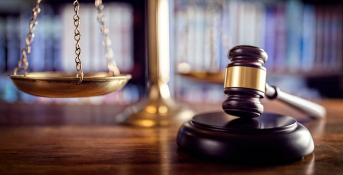 Judge gavel, scales of justice and law books in court