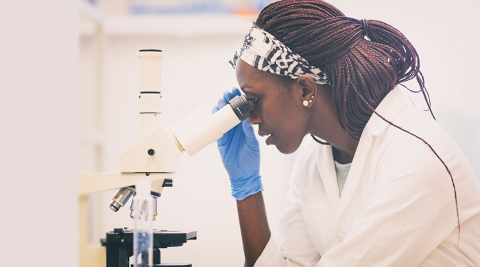 Woman looking in a microscope