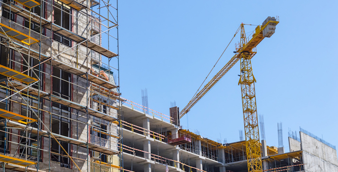 Сonstruction site. Building with crane on the sky background