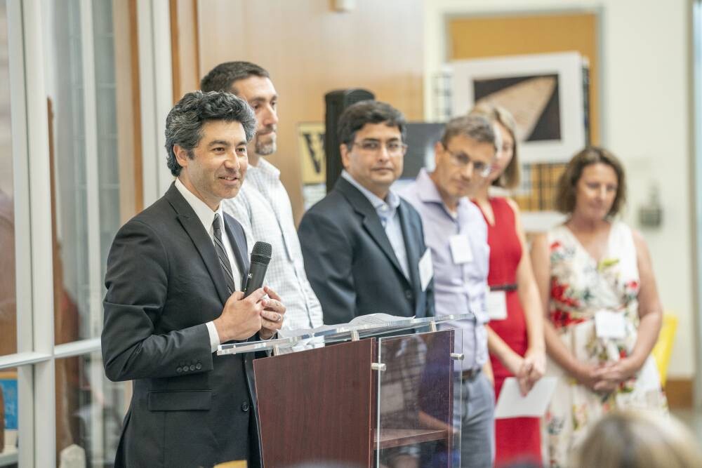 FCAI director speaks at the grand opening of the Frist Center for Autism and Innovation accompanied by deputy directors.
