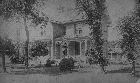 Vaughn_Home-hires Black and white old fashioned photo of house and cottage with residents standing in yard