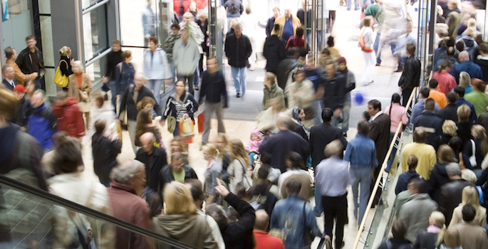 very crowded shopping center lobby and escalator