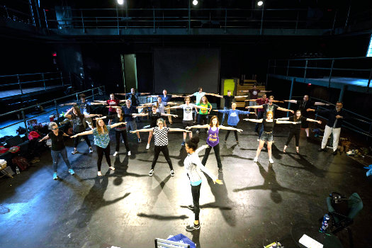 Choreographer Tosha Pendergrast leads 'The Tempest' cast in warm-up movement at Neely Auditorium (Joe Howell/Vanderbilt University)