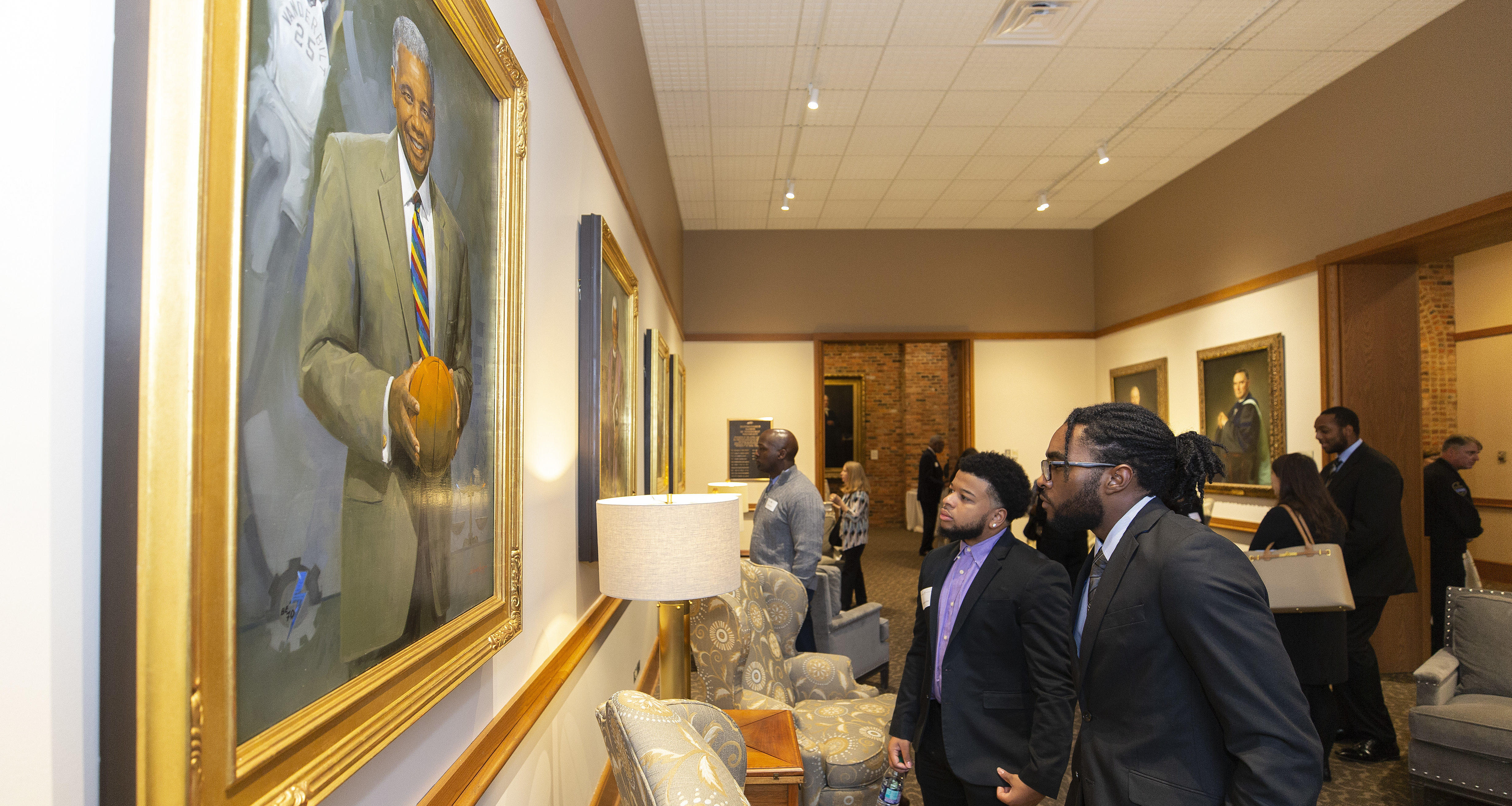 Individuals looking at the Vanderbilt Trailblazer portraits in Kirkland Hall (Vanderbilt University/Joe Howell)