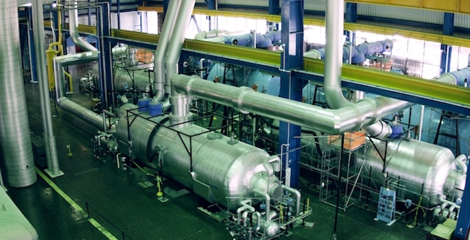 image of interior of nuclear power plant focused on a network of pipes and tanks
