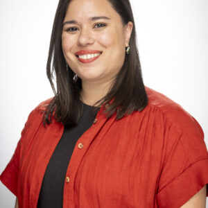 Woman smiling in red and black shirt