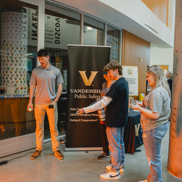 Lab safety fair participant practicing using a fire extinguisher