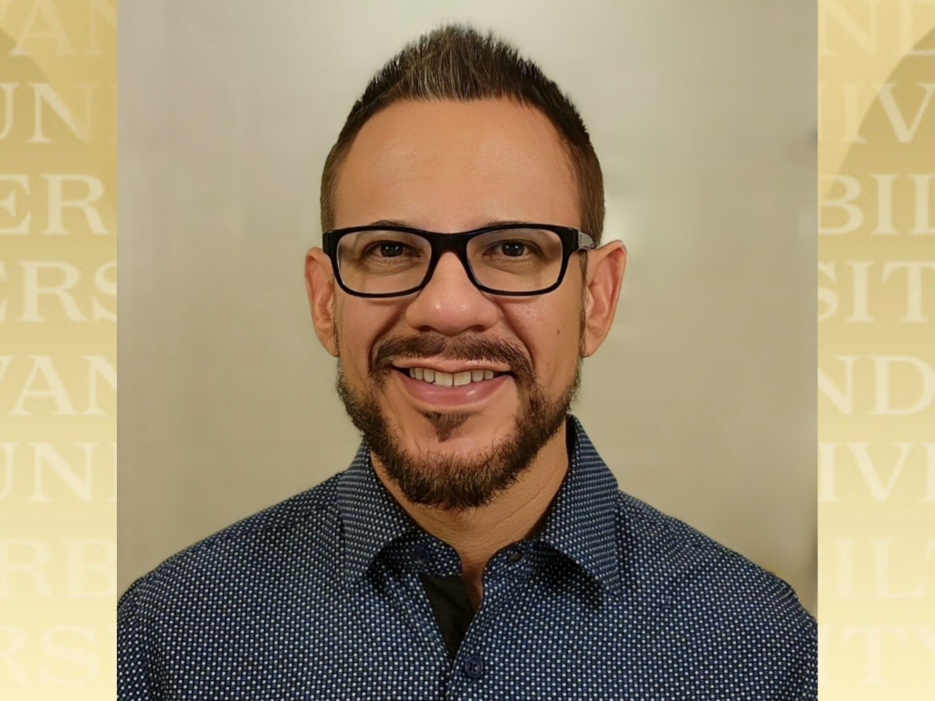Efrain Garcia headshot over Vanderbilt gold background