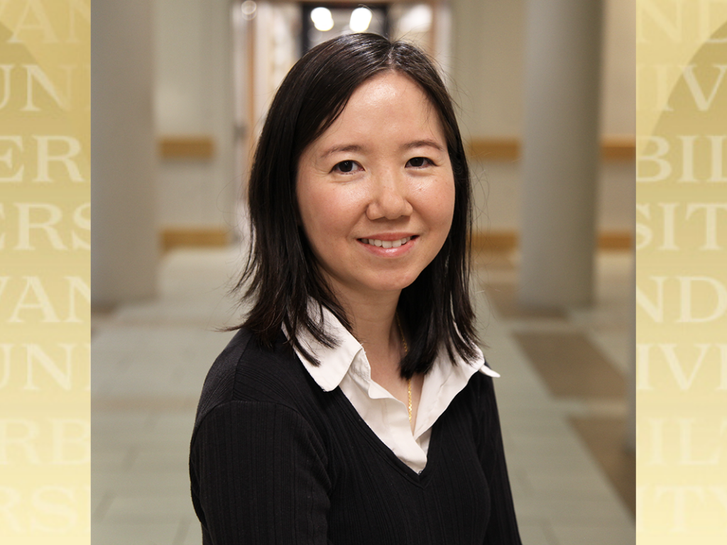 Quynh Anh Nguyen headshot with Vanderbilt gold background