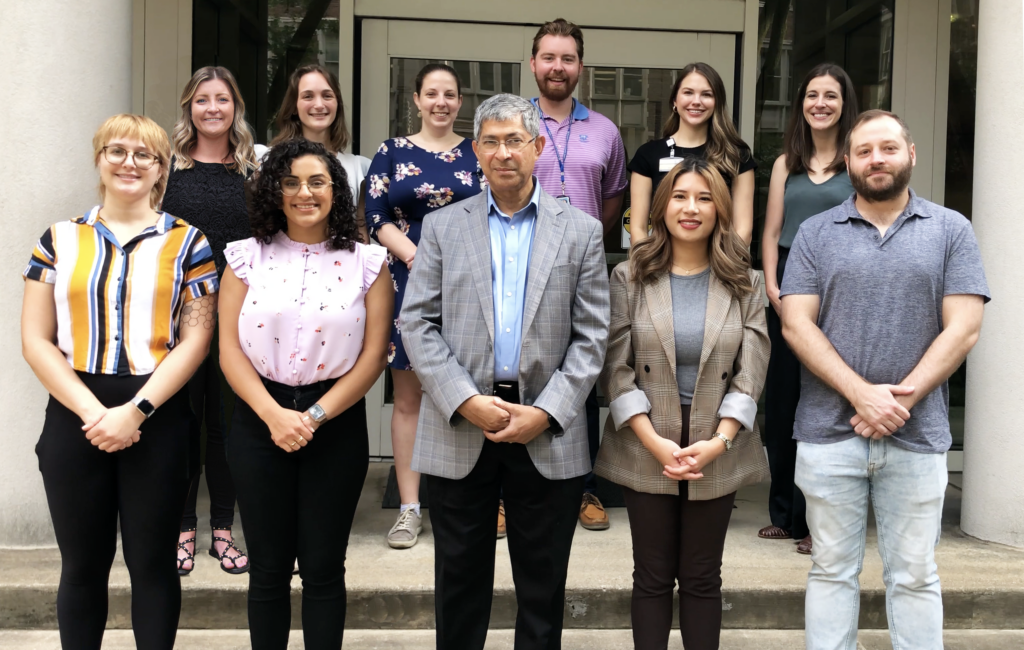A group of 10 students in two rows, with Dean John Kuriyan in the middle in the front.