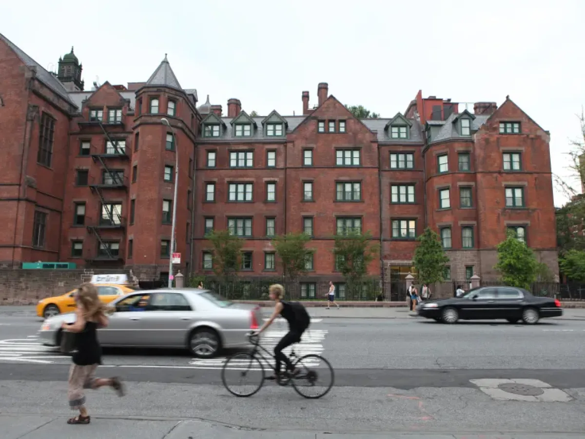 Vanderbilt's NYC campus with bicyclists riding on the street in front of it