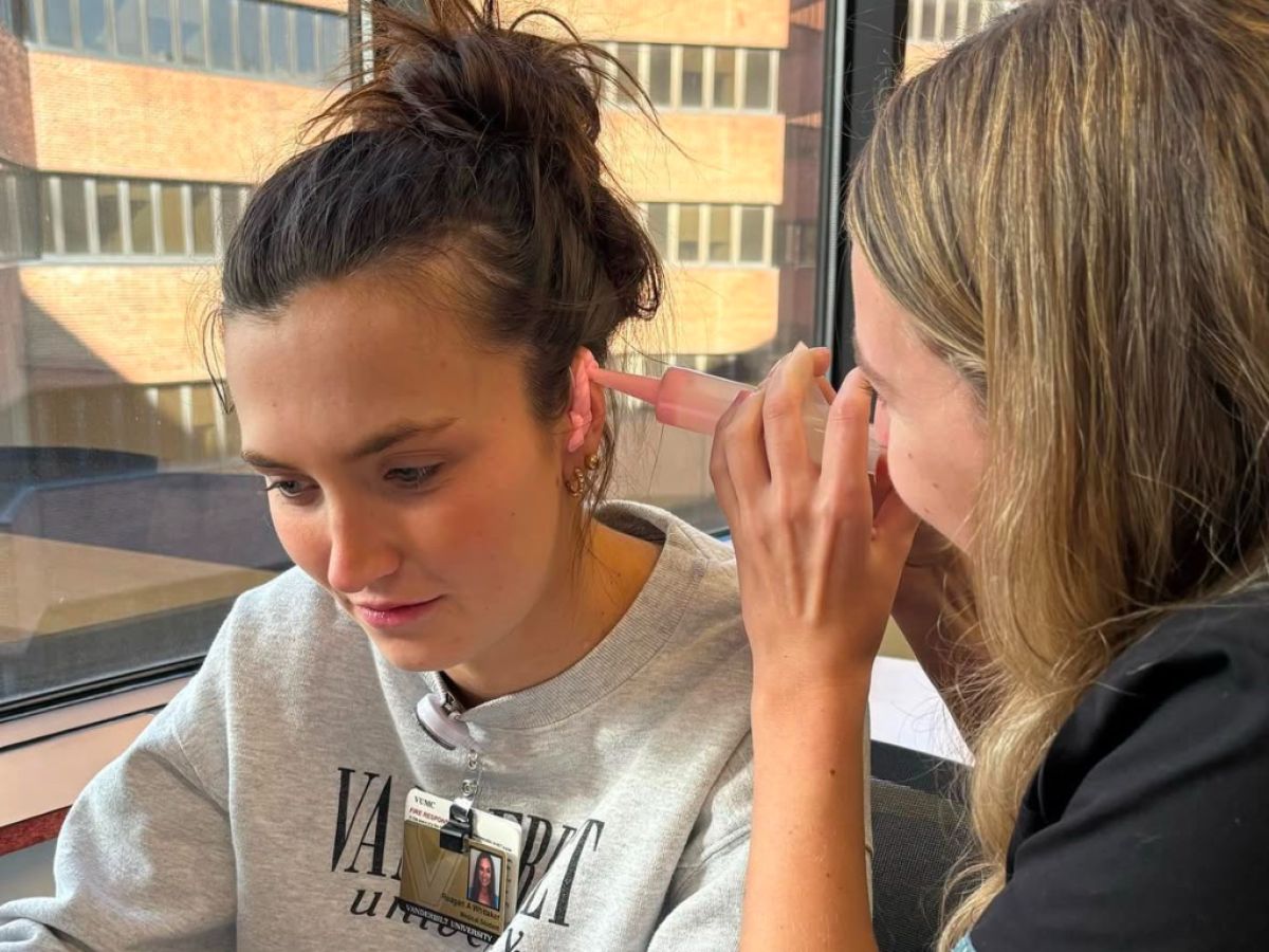 An audiology student practices making silicone ear molds on another student at Vanderbilt School of Medicine.