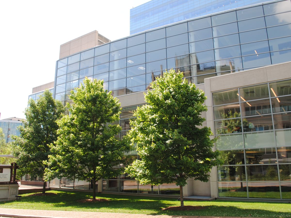 Modern glass building on Vanderbilt University Medical Center campus with green trees in front