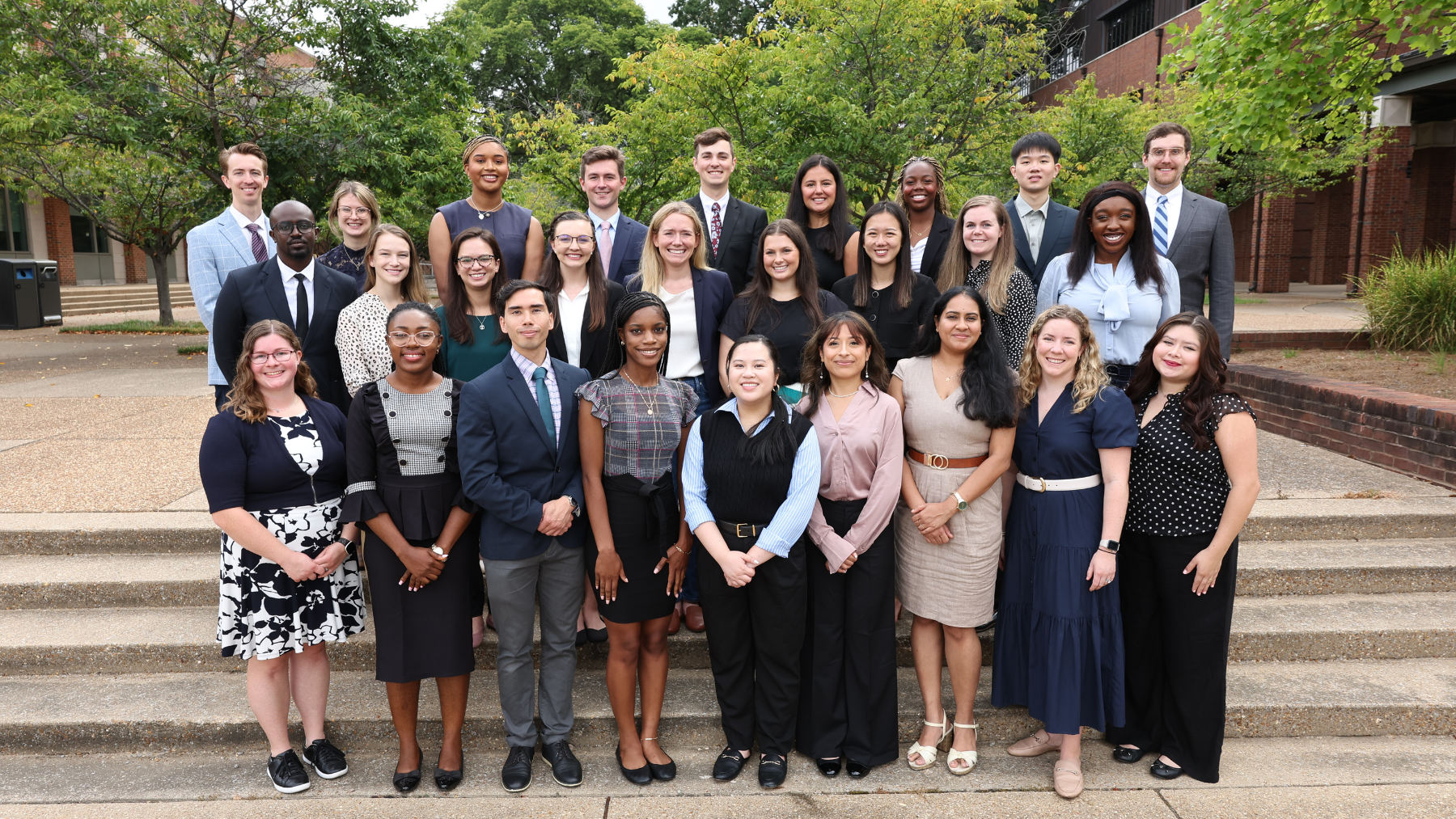 A group of smiling students and faculty poses for a photo at a VUSM MPH event.