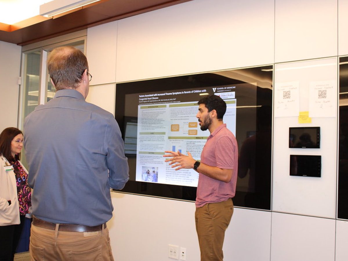 A medical student presents research on a smart screen.