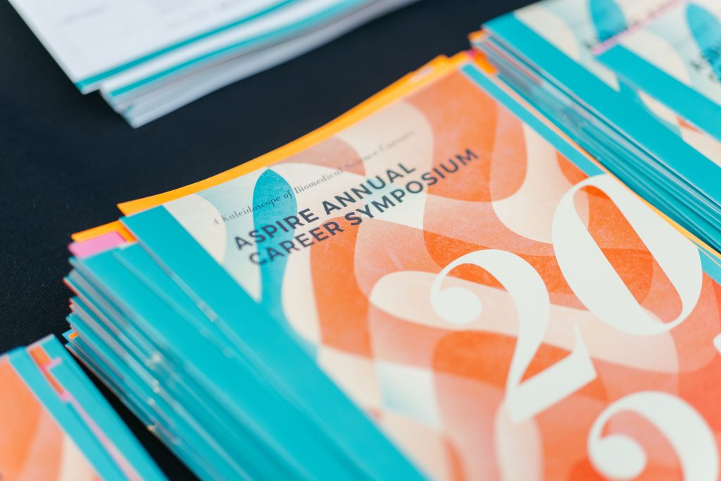 Closeup of the 2025 ASPIRE Annual Career Symposium pamphlet