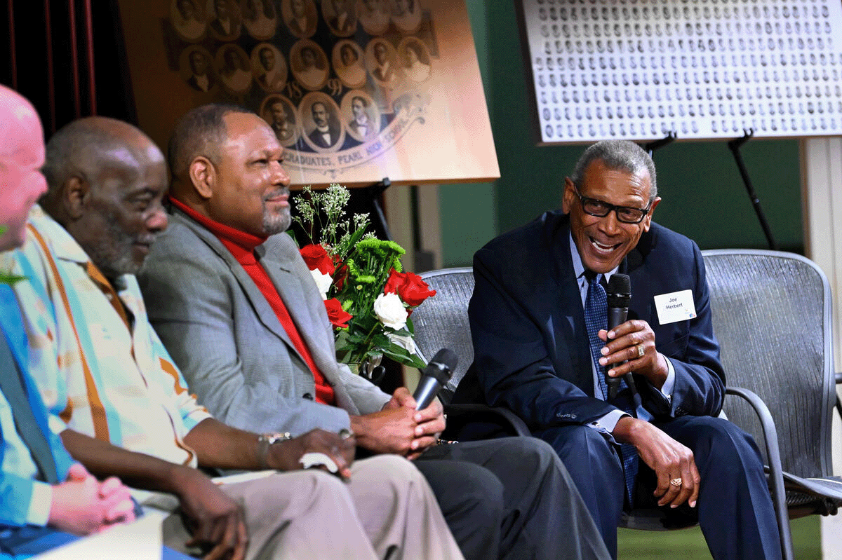 Pearl High School alumni engage in a panel discussion on stage at the Nashville Public Library