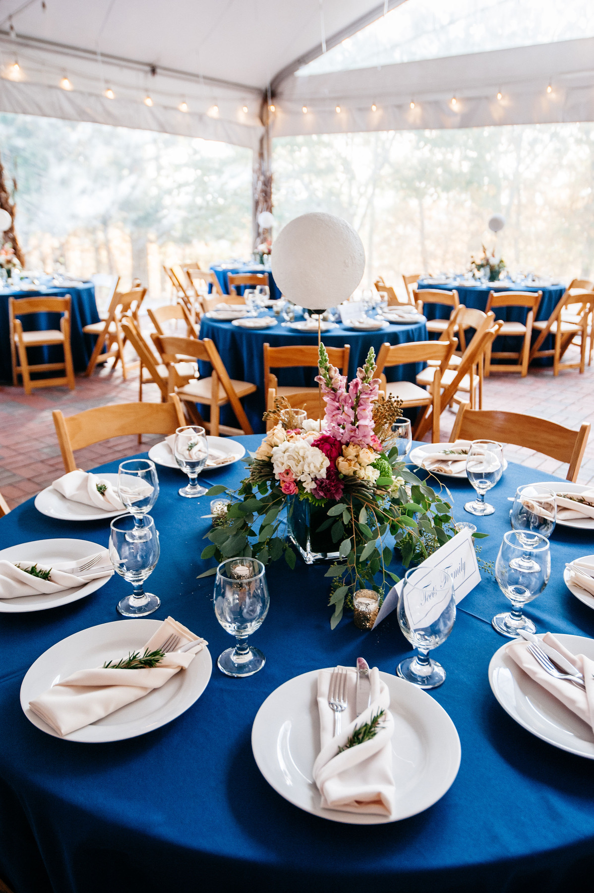 Table with flower centerpiece during a Dyer Observatory event under the tented patio