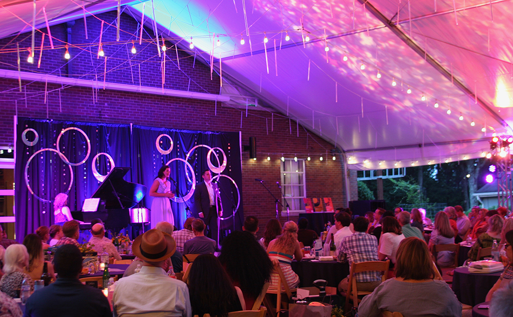 Evening Opera on the Mountain performance under a tent with colorful lighting and a seated audience at Vanderbilt Dyer Observatory.