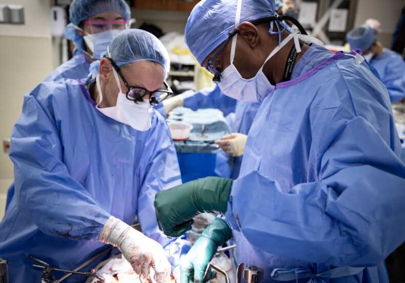 Martin Montenovo, MD, left, and Wali Johnson, MD, perform a liver transplant in 2024. (photo by Erin O. Smith)