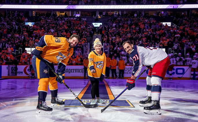    Monroe Carell Jr. Children’s Hospital at Vanderbilt patient Maylee Wilshire served as Mayor of Smashville at the recent Nashville Predators Hockey Fights Cancer Night. Here, Wilshire drops the puck with Predators’ captain Roman Josi, left, and Columbus Blue Jackets’ captain Nick Foligno. Hockey Fights Cancer provides an opportunity to bring special guests from Children’s Hospital to Bridgestone Arena and to let the young hockey fans have a one-of-a-kind experience with the Nashville Predators. All money raised during the games benefits the 365 Pediatric Cancer Fund at Children’s Hospital to support childhood cancer initiatives.